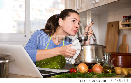 Woman looking for recipe on Internet 75549314