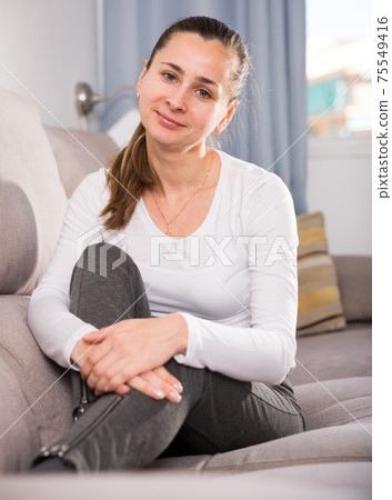 Woman lying and posing on couch 75549416