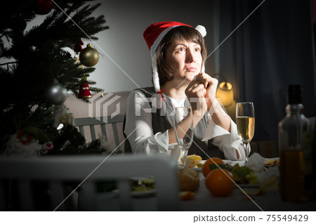 Frustrated woman alone during christmas holiday 75549429