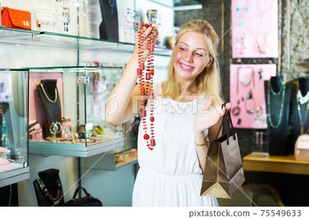 Woman buying long necklace Woman buying long necklace 75549633