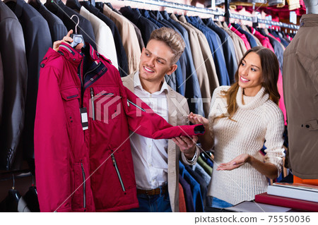 Couple deciding on warm suit in men’s cloths store Couple deciding on warm suit in men’s cloths store 75550036