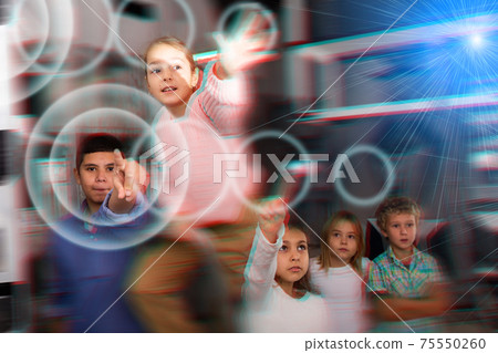 Girl and boy trying to solve puzzles to get out of escape room; reaching for key Girl and boy trying to solve puzzles to get out of escape room; reaching for key 75550260