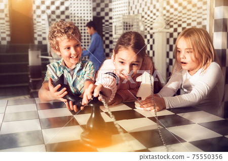 Tween children solving riddles in quest room, toned image Tween children solving riddles in quest room, toned image 75550356