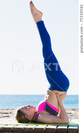 Adult woman practicing different yoga exercises 75550592