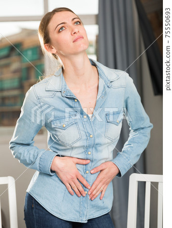 Portrait of a girl suffering from pain in the neck Portrait of a girl suffering from pain in the neck 75550693