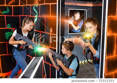 Portrait of teenager girl with laser gun having fun with her fam Portrait of teenager girl with laser gun having fun with her fam 75551353