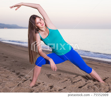 Portrait of sportswoman which is doing excercises on endurance 75552009