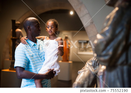 Father and daughter looking at exhibits Father and daughter looking at exhibits 75552190