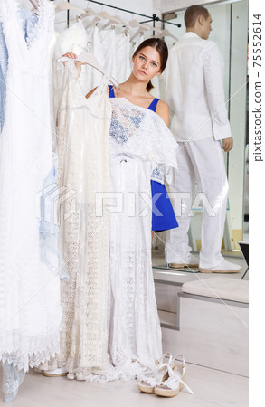 Woman choosing bridal dress 75552614