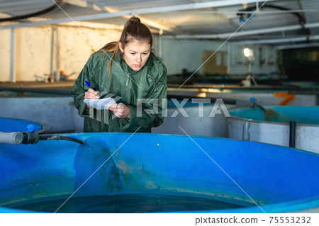 Woman controlling fish growth 75553232