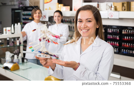 Nail technician offering color of nail polish Nail technician offering color of nail polish 75553368