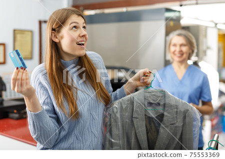 Customer paying with bank card Customer paying with bank card 75553369