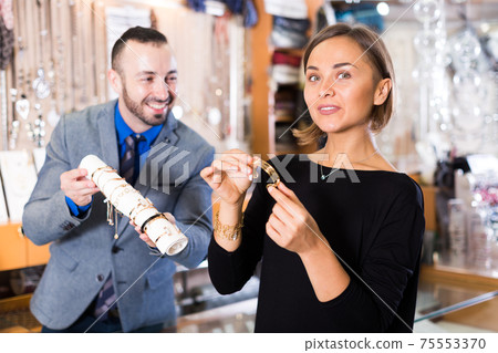 buyer woman choosing bracelet buyer woman choosing bracelet 75553370