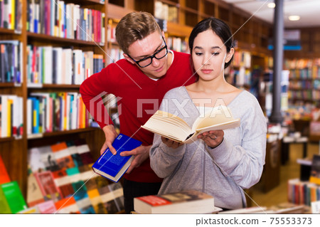 Guy interested in book that girl reading Guy interested in book that girl reading 75553373