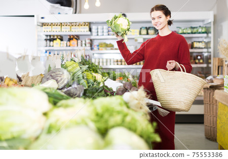 Girl showing fresh cauliflower Girl showing fresh cauliflower 75553386