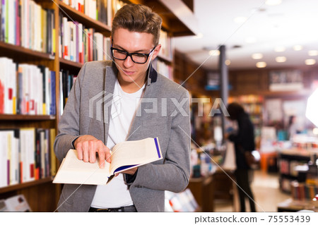 man pointing at something in open book man pointing at something in open book 75553439