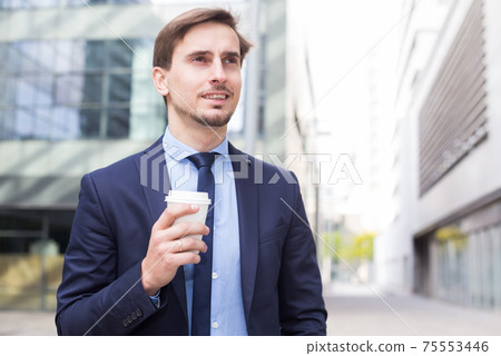 Portrait of cheerful male standing outdoor 75553446