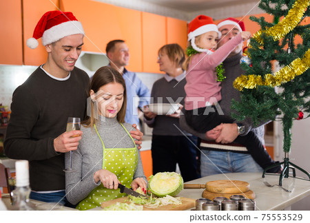 Family preparing for Christmas dinner Family preparing for Christmas dinner 75553529