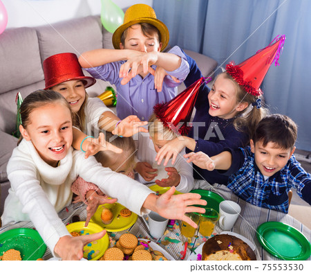 Boys and girls behaving jokingly during friend’s birthday party Boys and girls behaving jokingly during friend’s birthday party 75553530