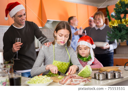 Woman with kid girl preparing family dinner Woman with kid girl preparing family dinner 75553531