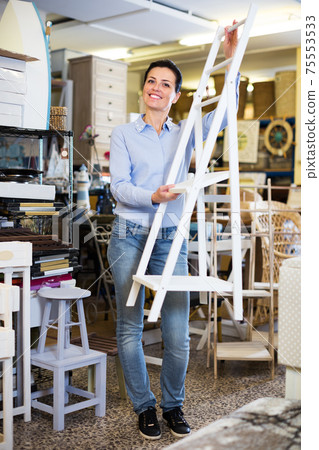 Female choosing stepladder in store Female choosing stepladder in store 75553533