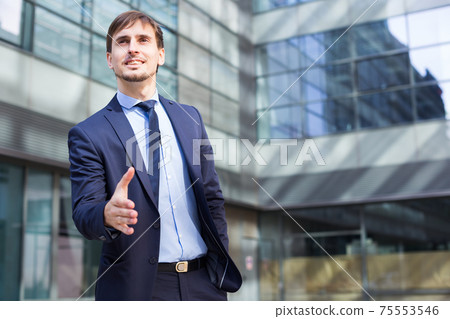 Smiling businessman standing outdoors 75553546