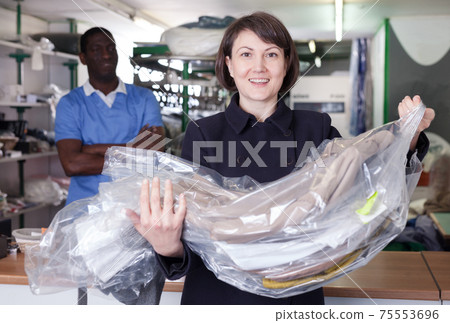 Satisfied female client with clean garment 75553696