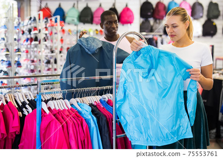Female shopper choosing sport clothes 75553761