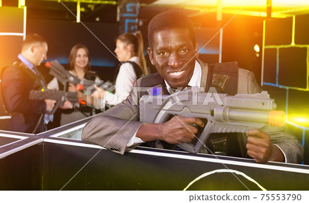 African American with laser gun playing laser tag 75553790