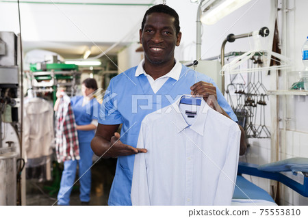 Man worker showing clean clothes Man worker showing clean clothes 75553810