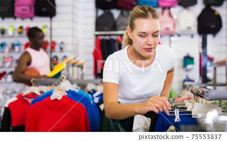 Woman choosing sportswear Woman choosing sportswear 75553837