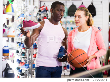 Male and female customers shopping sports shoes Male and female customers shopping sports shoes 75553851