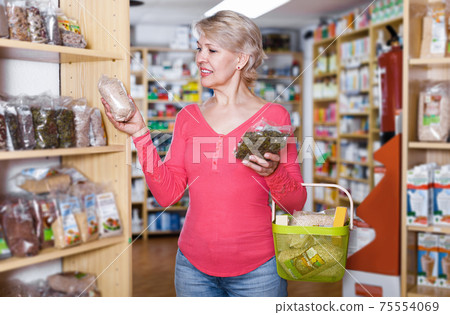 Client searching for healthy food in bio food shop Client searching for healthy food in bio food shop 75554069