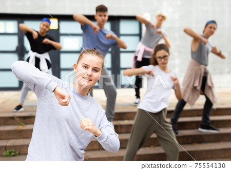 Active girls and boys dancing hip hop on a street 75554130