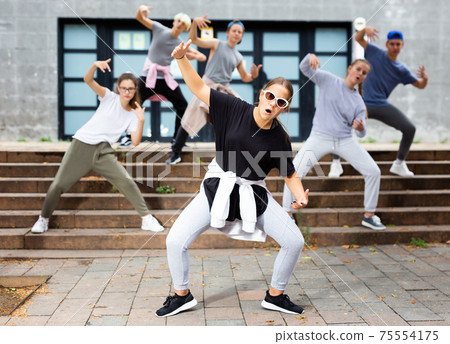 Active girls and boys dancing hip hop on a street 75554175