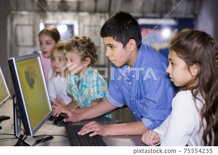 Group of friendly kids are concentrating on finding a way out of bunker room Group of friendly kids are concentrating on finding a way out of bunker room 75554235