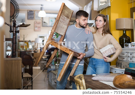 Couple arranging furniture in apartment Couple arranging furniture in apartment 75554246