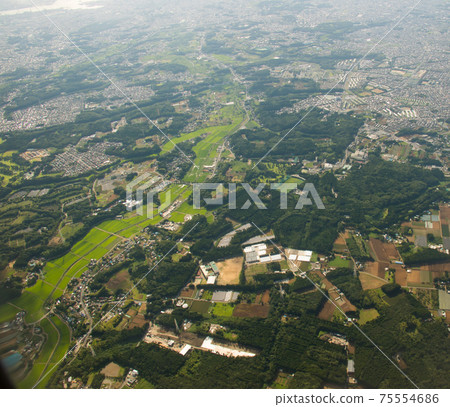 Land with lots of greenery seen from an airplane Background daytime 75554686