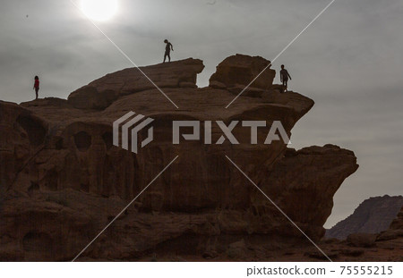 Tourists Climbing Rocks Near Wadi Rum Jordan Look Like Alien Silhouettes Tourists Climbing Rocks Near Wadi Rum Jordan Look Like Alien Silhouettes 75555215