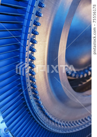 The rotor disk with the blades of a turbojet gas turbine engine with a blue glow. The rotor disk with the blades of a turbojet gas turbine engine with a blue glow. 75556178