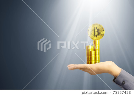 Business hand holding stack of golden bitcoin Business hand holding stack of golden bitcoin 75557438