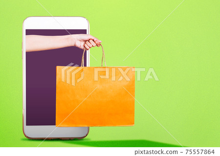 Hand with shopping bags coming out from the phone screen Hand with shopping bags coming out from the phone screen 75557864