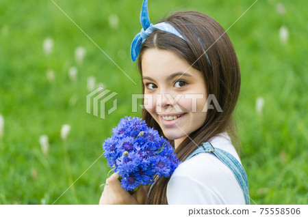 Get flowers for womens day. Happy girl hold cornflowers Get flowers for womens day. Happy girl hold cornflowers 75558506
