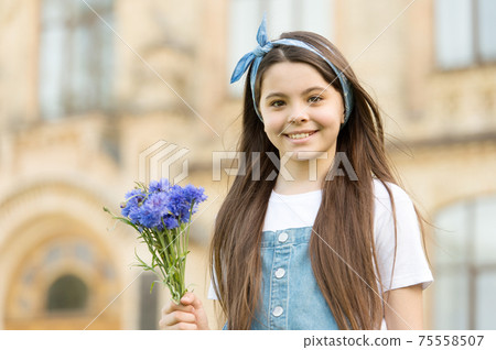Little girl cornflowers bouquet holiday greetings, mothers day concept Little girl cornflowers bouquet holiday greetings, mothers day concept 75558507