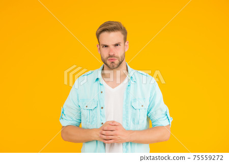serious man with sexy bristle wear casual shirt on yellow background, confidence 75559272