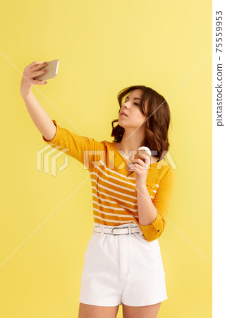 woman with vanilla ice cream making selfie 75559953