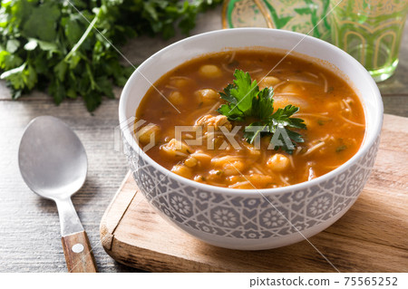 Harira soup in bowl on wooden table. Typical Moroccan food. Ramadan concept. 75565252