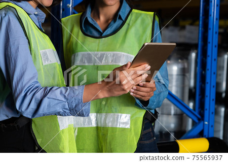 Female warehouse worker working at the storehouse 75565937
