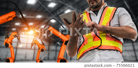 Engineer use advanced robotic software to control industry robot arm in factory 75566021