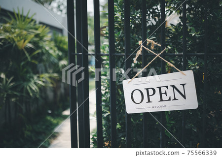 Open sign hanging in front of cafe Open sign hanging in front of cafe 75566339